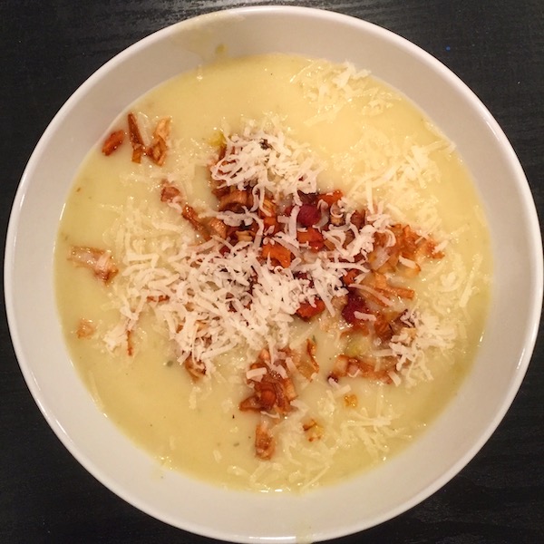 A delicious bowl of potato soup sprinkled with tons of Parmesan cheese.