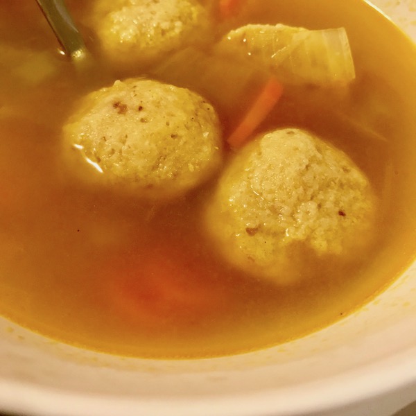 A bowl of piping hot matzo ball soup
